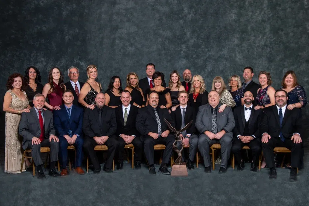Owner and President Andy Royalty (seated, center) is flanked by Royalty Roofing executives and their significant others at the Duro-Last 2022 National Sales Seminar.