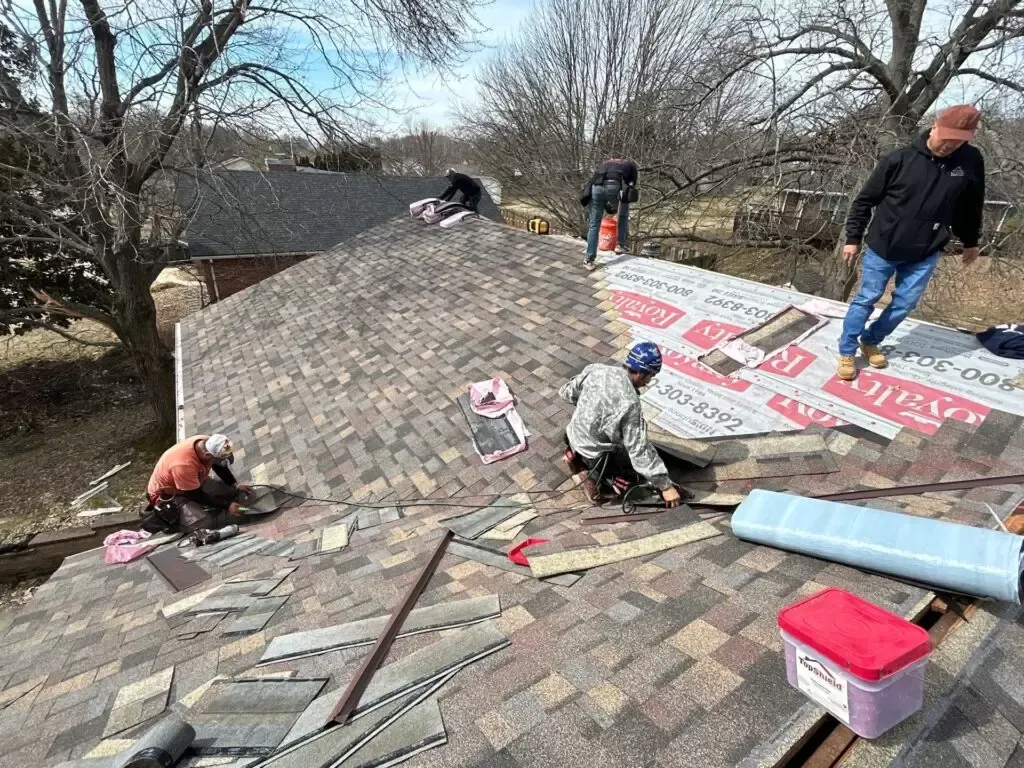 roofing crew replacing shingle roof on home in Indiana