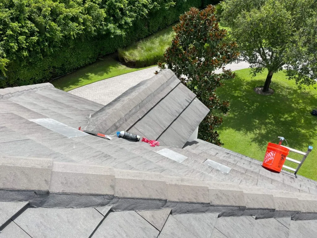 tools and later on roof showing newly installed roof tiles still drying