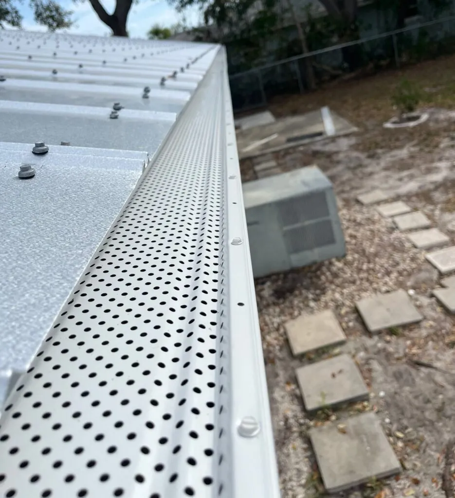 close up of gutter guards installed on a metal roof