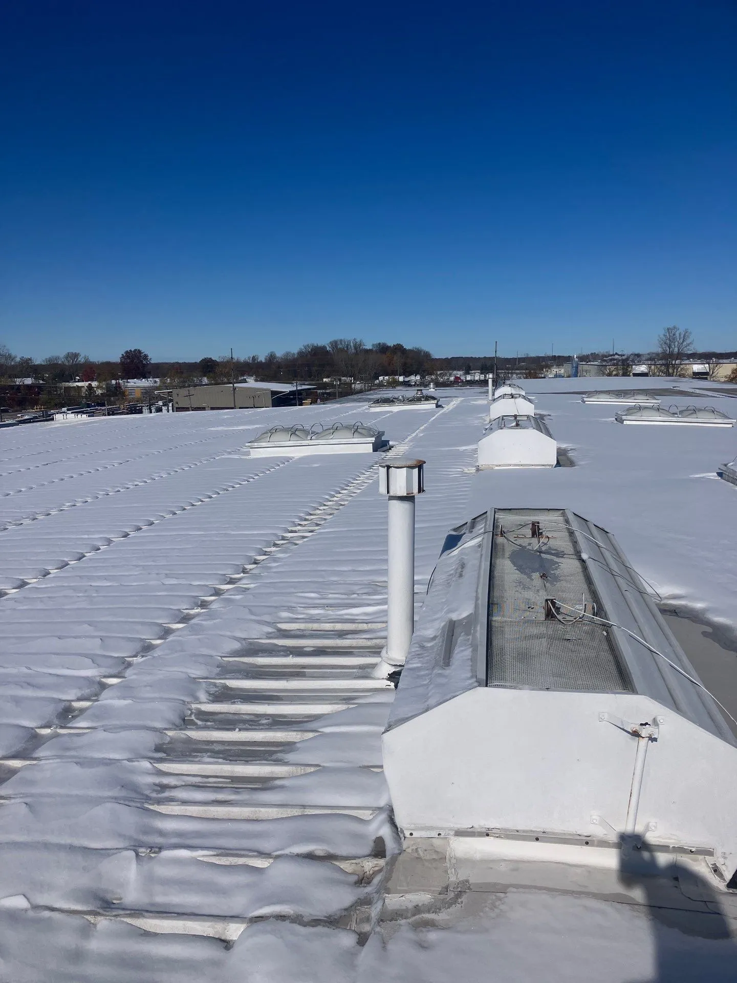 commercial metal roof covered in snow
