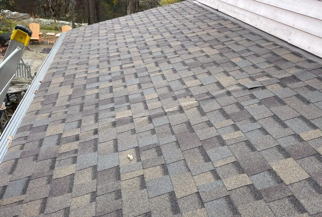 line running down shingles on a roof on a home showcasing need of repair