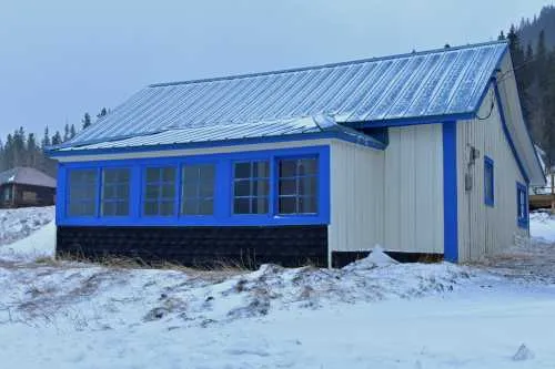 blue metal roof on home in the winter